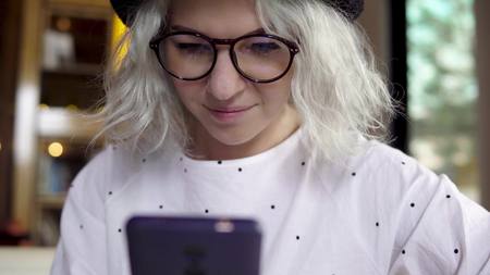 Woman using smartphone, texting on mobile phoneの写真素材