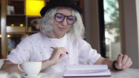 Businesswoman writing in the daily plannerの写真素材