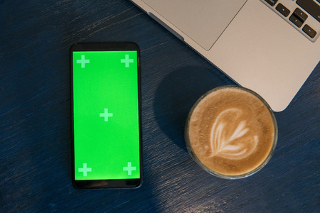 Workplace with laptop, mobile phone and coffee indoorsの写真素材