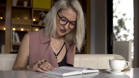 Student is reading a book in cafeの写真素材