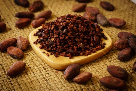 Cacao nibs and cocoa beans on burlapの写真素材