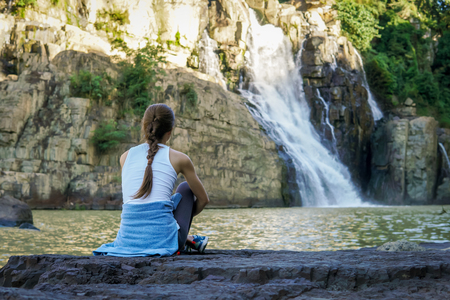 Woman sitting near waterfall in Dalat, Vietnamの写真素材