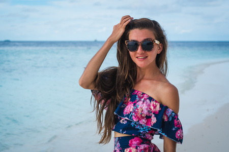 Happy woman on beach with transparent water of ocean in Maldivesの写真素材