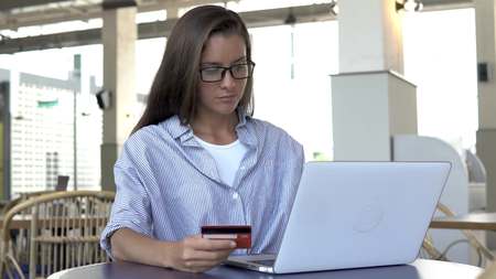 Woman shopping online with laptop computerの写真素材