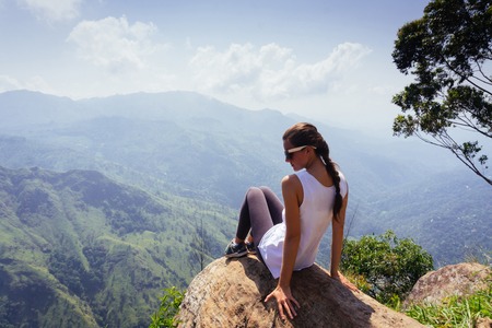 Travel concept. Female traveller on Ella Rocka enjoying mountain landscapeの写真素材
