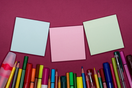 Directly above view of color pencils, blank sticky memo for text and design.の写真素材