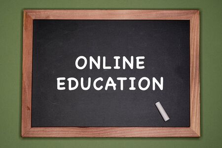 Online education written on chalkboard, green backgroundの写真素材