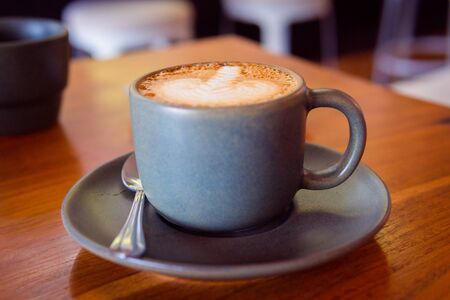 Cup of coffee on a wooden table. Hot cappuccinoの写真素材