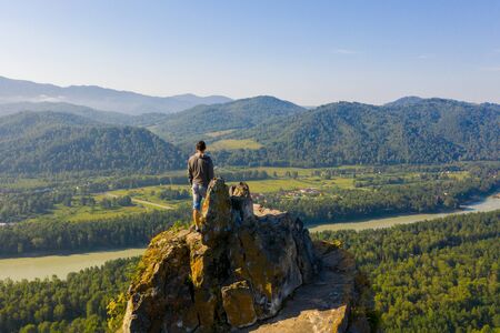 Hiker standing on top of a mountain and enjoying view of Altaiの写真素材