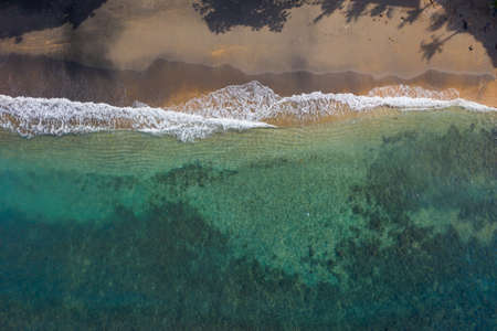 Aerial shot of ocean water with sandy beach. Amed, Bali, Indonesiaの写真素材