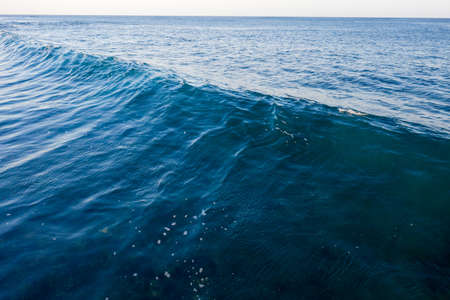 Blue ocean wave at sunset. Aerial viewの写真素材