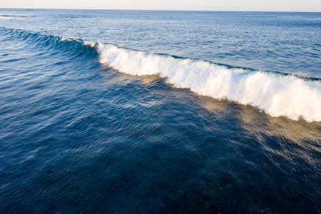 Aerial view of giant ocean wave foamingの写真素材