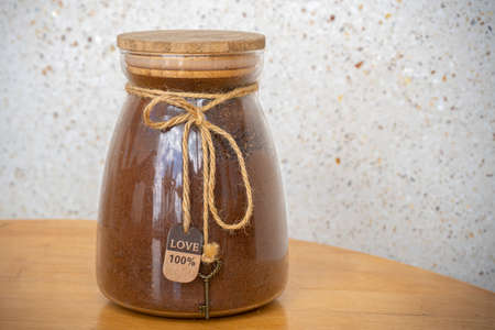 Ground coffee in glass jars on a wooden table.の写真素材