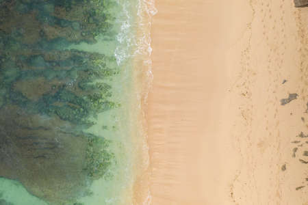 Aerial view of sandy beach and ocean with wavesの写真素材