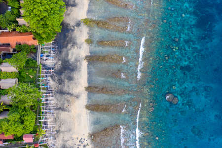The tropical bay with sandy and stony beach, boats. Amed, Bali, Indonesia.の写真素材
