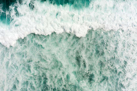 Top aerial view of giant ocean waves crashing and foaming.の写真素材
