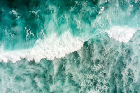 Top aerial view of giant ocean waves crashing and foaming.の写真素材