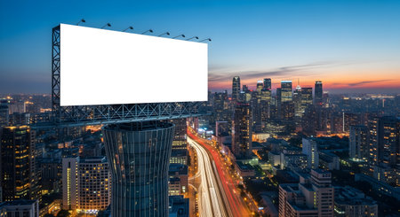 A large, blank billboard stands tall above Bangkok, Thailand, at dusk. The cityscape glows with lights, and the sky transitions from blue to orange.の素材