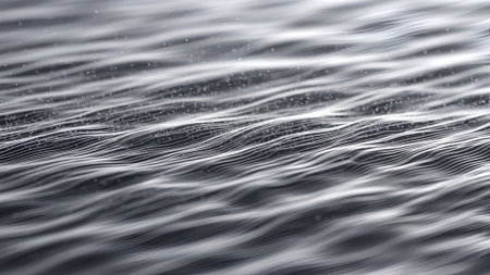 Close-up of water surface with gentle ripples, creating an abstract texture. Soft light reflects, enhancing the fluid movement and creating a calming, serene mood.の素材