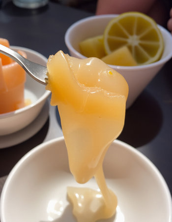 Slices of lemon on a fork in a restaurant, close upの写真素材