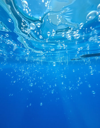 Underwater view of the surface of the water. Blue background.