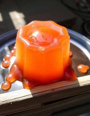 Candle in the shape of a heart on a wooden tray.の写真素材