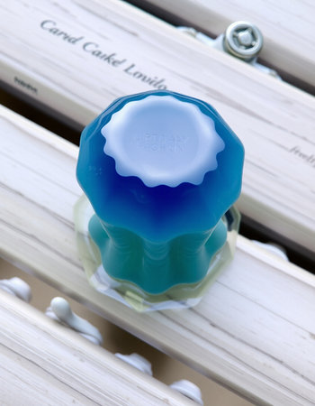 Close up of a blue candle in a wooden box on a shelf