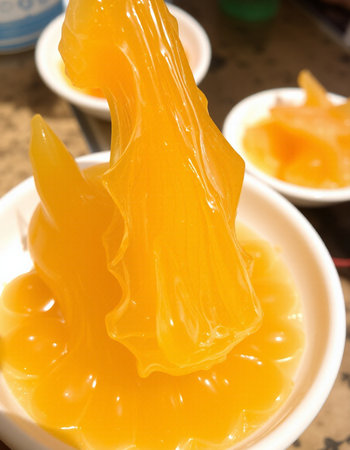 Close up of orange jelly in white bowl for Thai dessert, Thailand.の写真素材