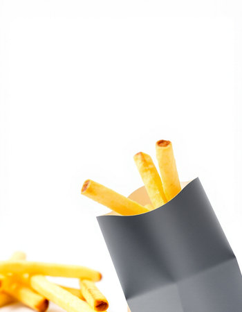 French fries in a black paper box isolated on white background. Copy space.の写真素材