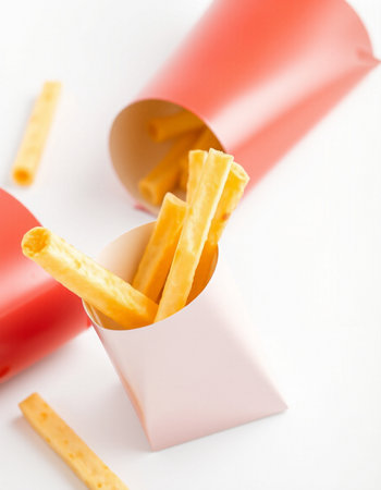 French fries in paper box on white background. Selective focus.の写真素材