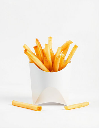French fries in paper box on white background. Fast food concept.