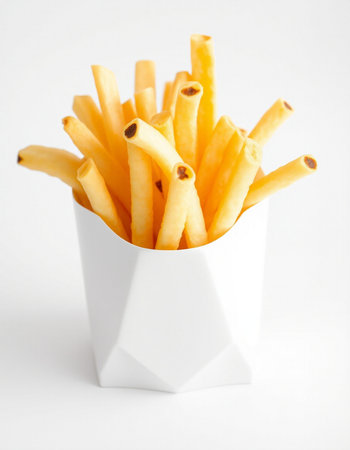 French fries in a white box on a white background, close-up