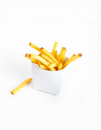 French fries in a white box on a white background. Selective focus.