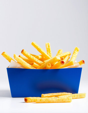 French fries in a blue box on a white background. Selective focus.の写真素材