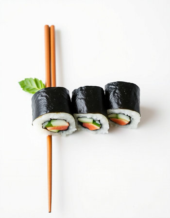 Sushi rolls with chopsticks on a white background, top view