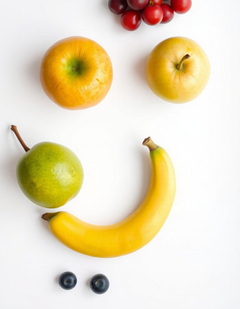 Fruits and vegetables in a smiley face on a white backgroundの写真素材
