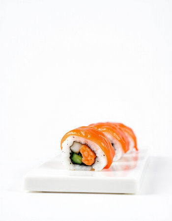 Sushi roll with salmon, shrimp, avocado and cucumber on white backgroundの写真素材