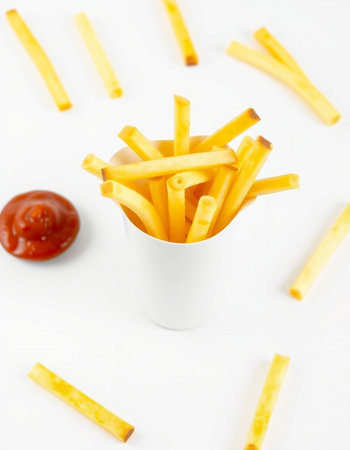 French fries with ketchup on white background. Selective focus.の写真素材