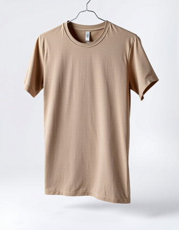 Brown t-shirt on a hanger on a white background.の写真素材