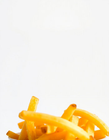 Golden French fries potatoes on a white background with space for text.の写真素材