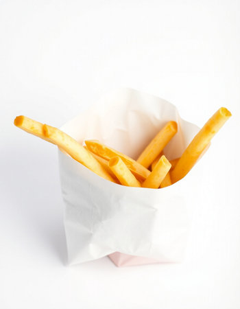 French fries in paper box isolated on white background. Selective focus.の写真素材