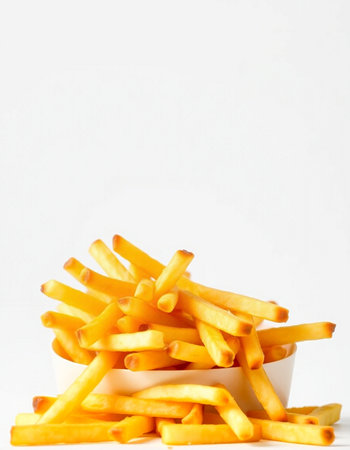 French fries in a bowl on a white background. Selective focus.の写真素材