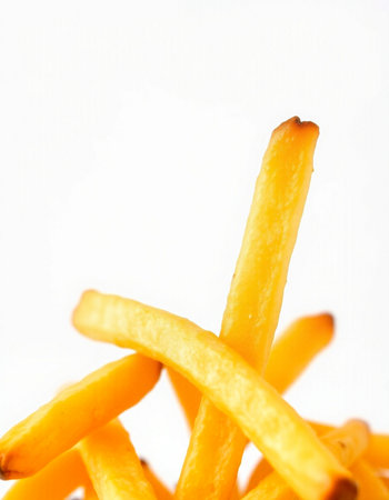 French fries on a white background. Selective focus. Toned.