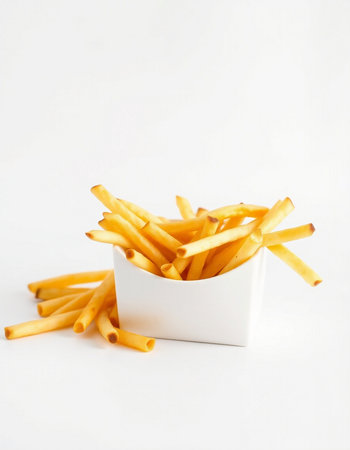 French fries in a bowl on a white background. Selective focus.の写真素材