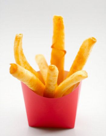 French fries in a red box on a white background close-upの写真素材
