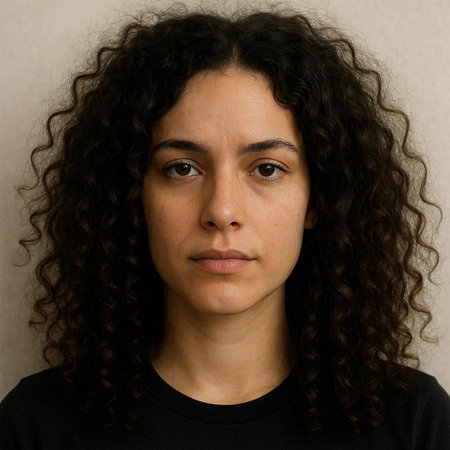 Portrait of a young woman with curly hair on a gray background