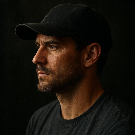 Portrait of a handsome man in a cap on a dark backgroundの写真素材