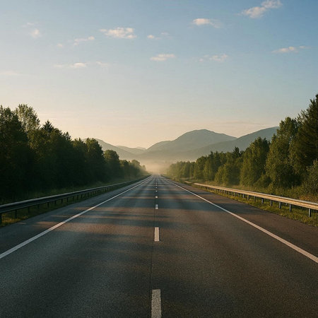 Asphalt road in the mountains. Summer landscape with blue sky.