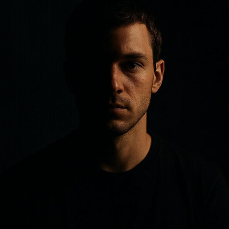 Portrait of a man in a black t-shirt on a dark background