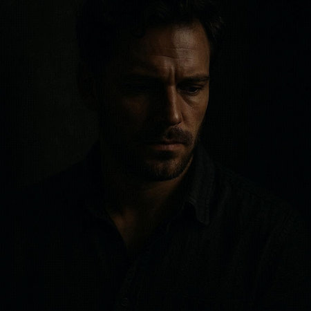 Portrait of a handsome man in a black shirt on a dark background